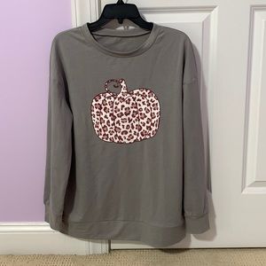 Small gray long sleeve shirt with pumpkin design.